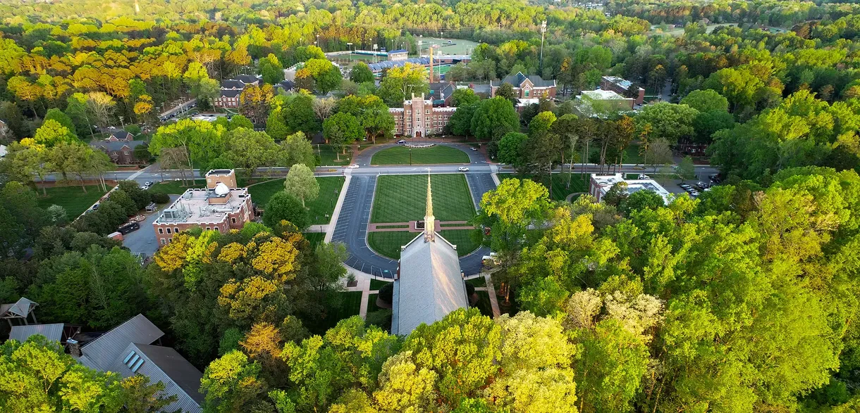 Aerial view of the Catawba College campus showing the central mall and chapel surrounded by trees