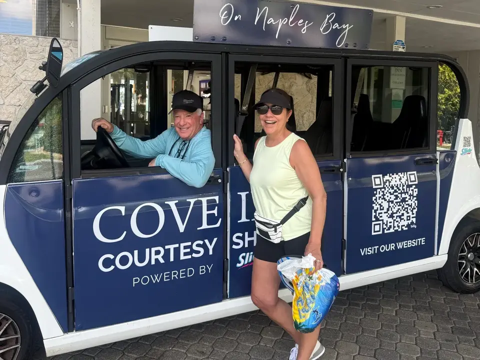 Two guests in the Cove Inn on Naples Bay courtesy shuttle outside the hotel in Naples, Florida