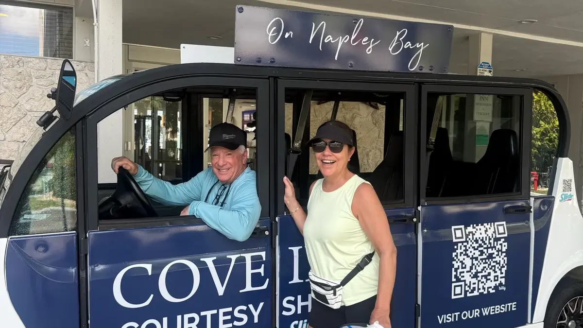 Two guests in the Cove Inn on Naples Bay courtesy shuttle outside the hotel in Naples, Florida